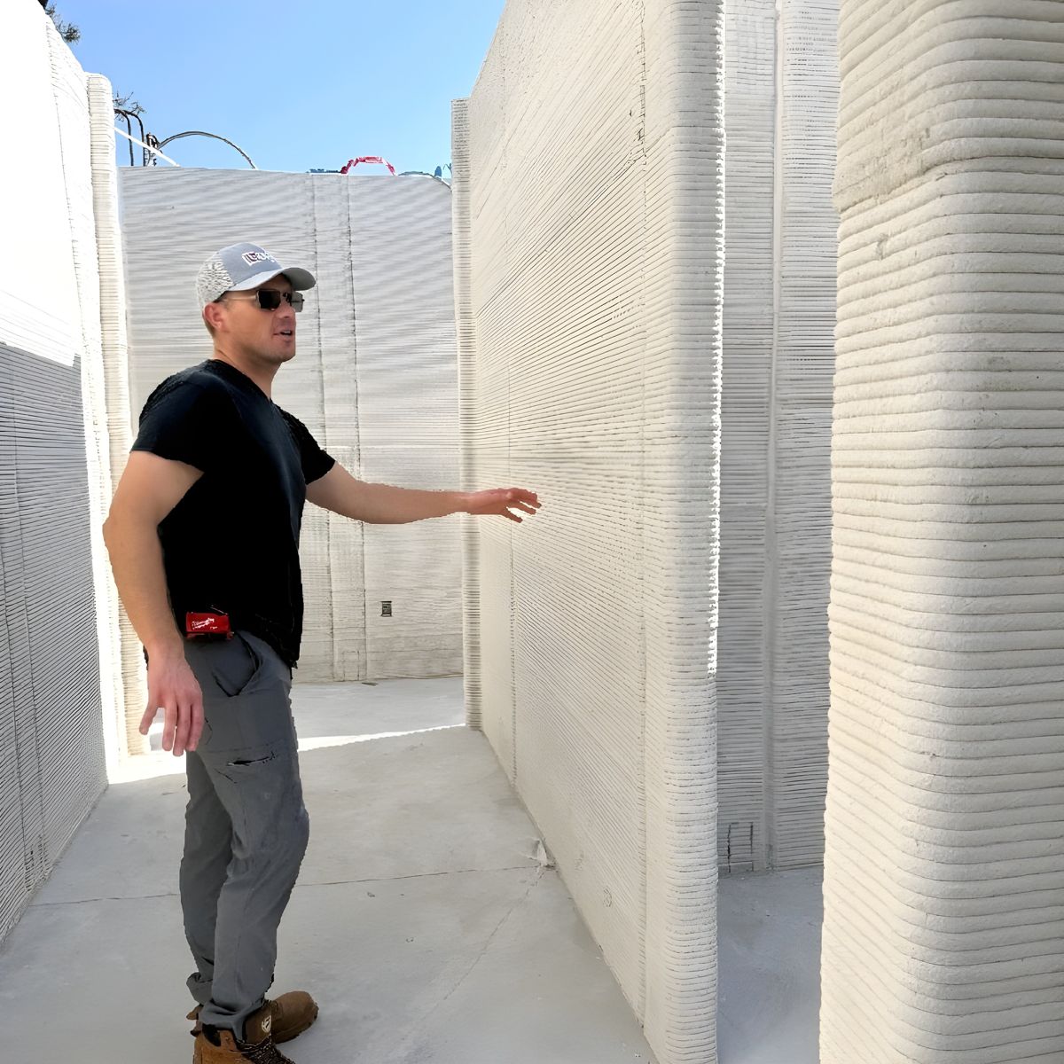 Drew Williams at a freshly printed 3D concrete wall